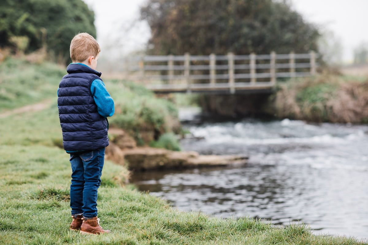 boy looking at river in Arlesey