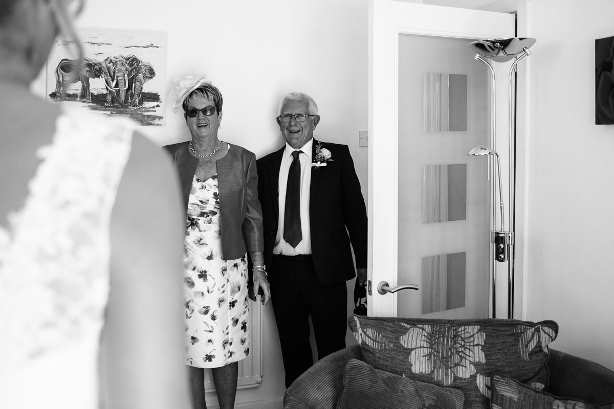 brides mother and father see her in her dress for the first time