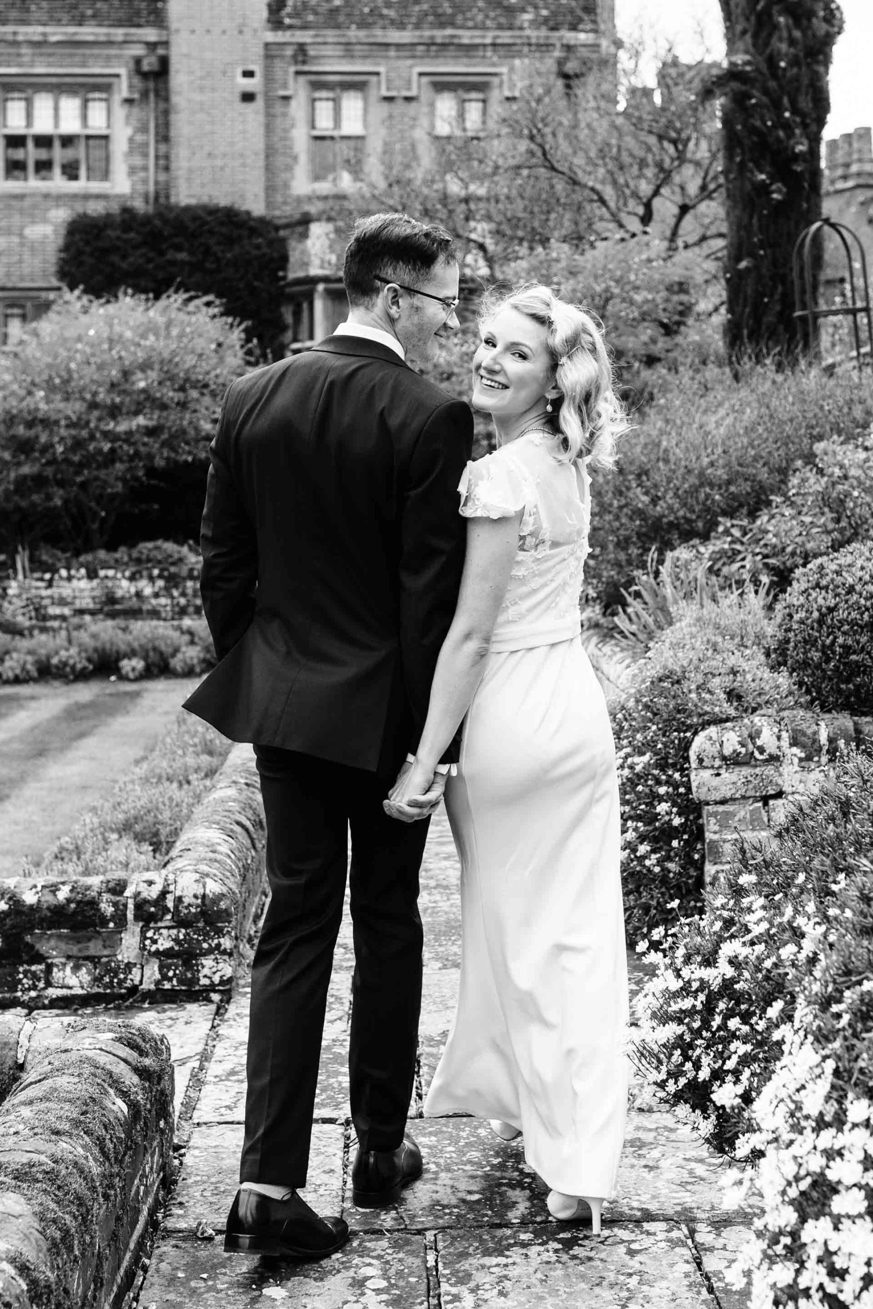 bride and groom holding hands